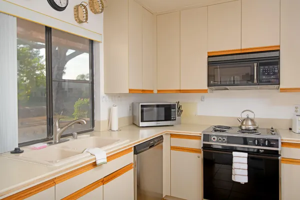 a kitchen with a sink and a stove top oven