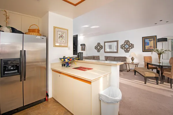 a kitchen with stainless steel appliances granite countertop a refrigerator and a sink