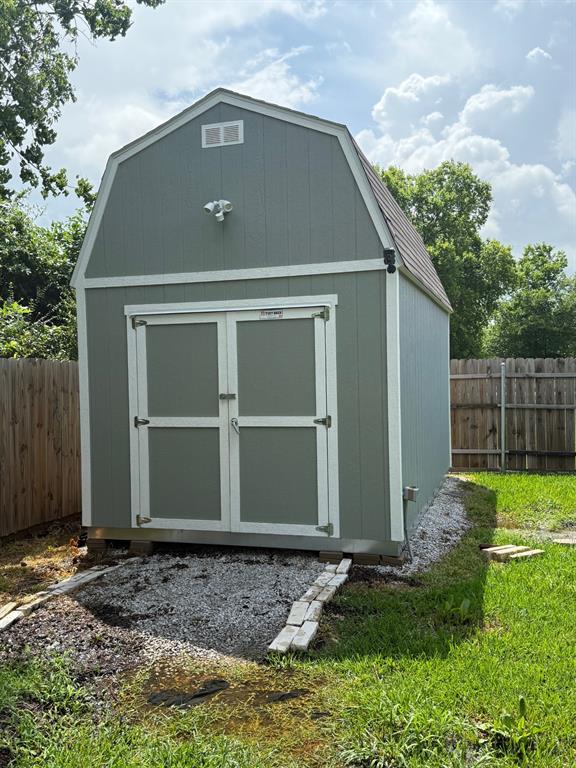 505 Thomas Street Terrell, TX 75160 - Photo 14 of 38 Gable-style storage building with a light green exterior and white trim