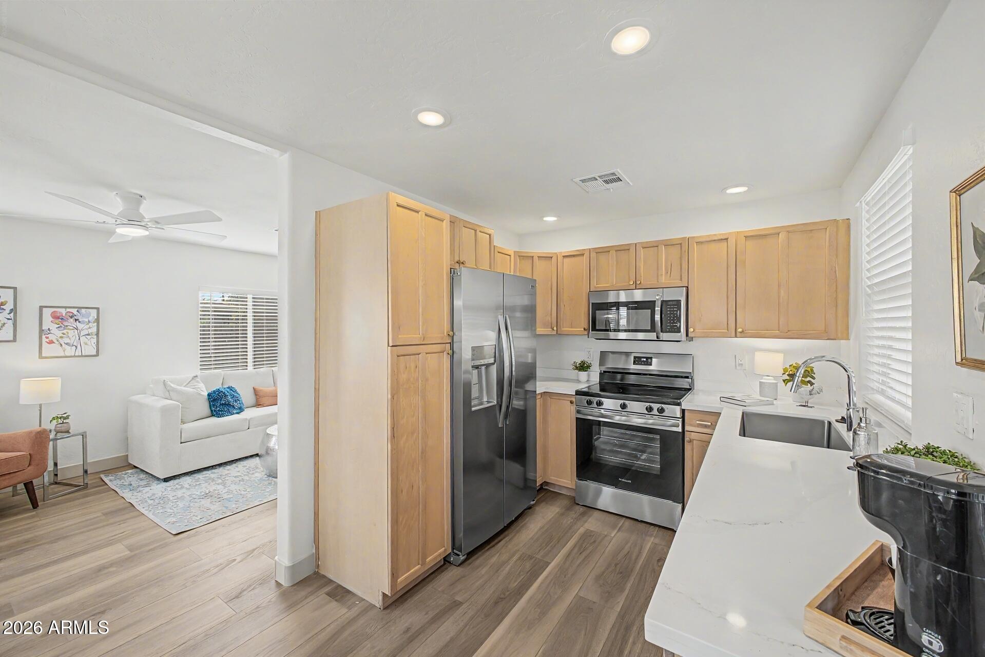 1914 East Monte Vista Road Phoenix, AZ 85006 - Photo 10 of 26 a kitchen with stainless steel appliances granite countertop a refrigerator stove microwave and sink