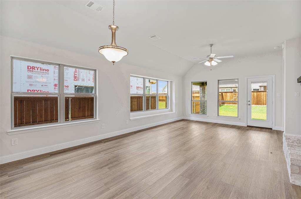 14566 Helena Street Pilot Point, TX 76258 - Photo 13 of 37 a view of an empty room with window and wooden floor