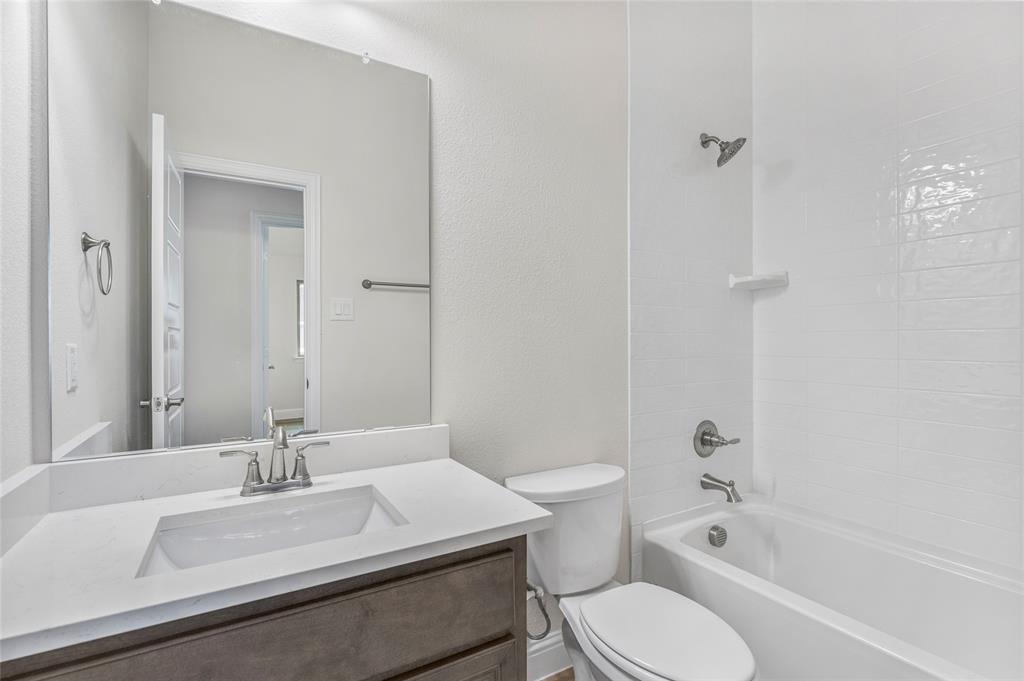 14566 Helena Street Pilot Point, TX 76258 - Photo 23 of 37 a bathroom with a sink toilet vanity and shower