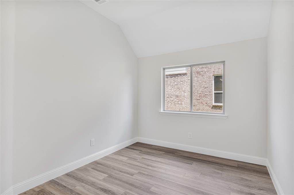14566 Helena Street Pilot Point, TX 76258 - Photo 24 of 37 an empty room with wooden floor and windows