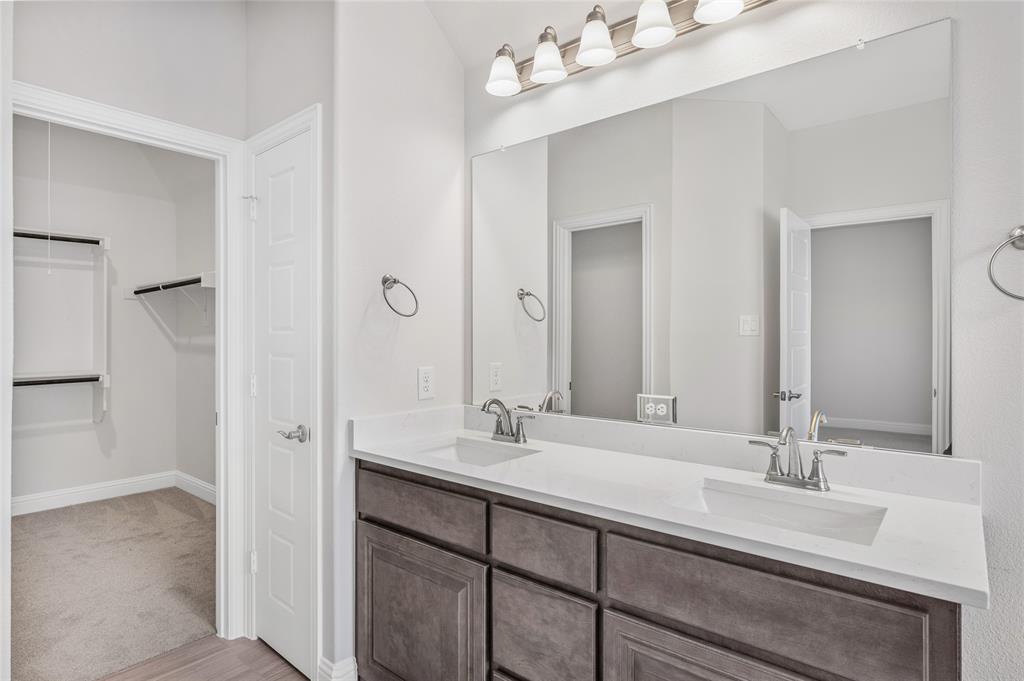 14566 Helena Street Pilot Point, TX 76258 - Photo 29 of 37 a bathroom with double vanity sinks and a mirror