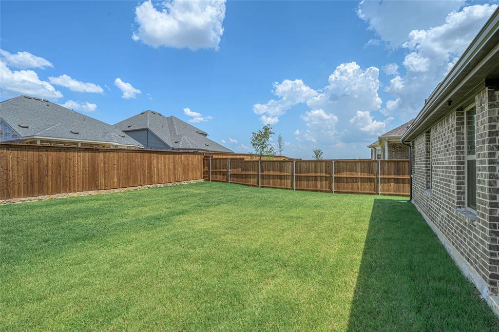 14566 Helena Street Pilot Point, TX 76258 - Photo 32 of 37 a view of a backyard with a garden