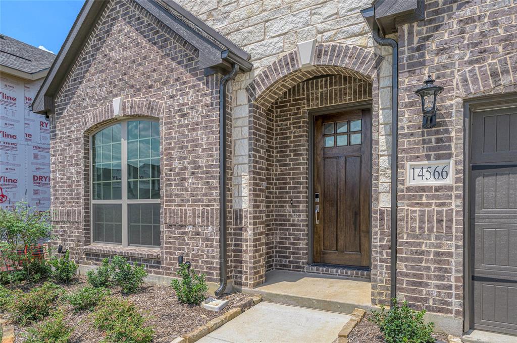 14566 Helena Street Pilot Point, TX 76258 - Photo 4 of 37 a front view of a house with large windows