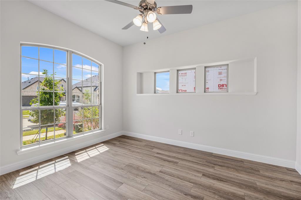 14566 Helena Street Pilot Point, TX 76258 - Photo 7 of 37 a view of an empty room with wooden floor and a window