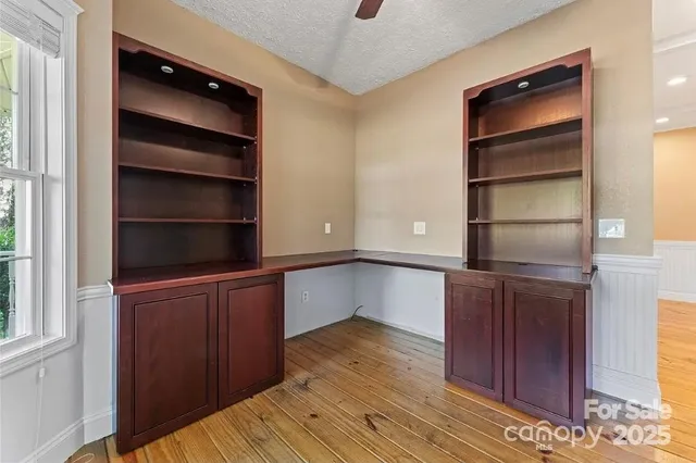 a kitchen with a cabinets and wooden floor