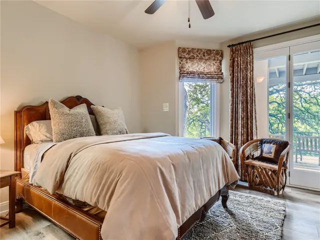 a bedroom with furniture and a large window