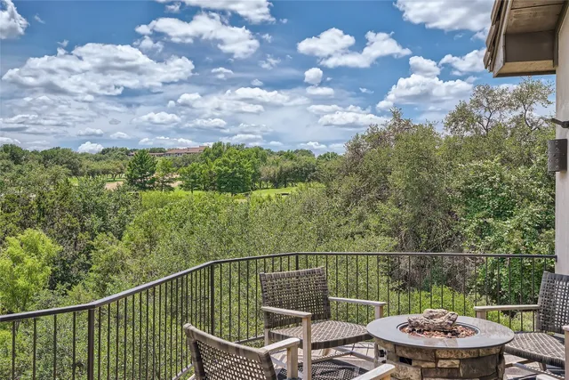 a view of a balcony with two chairs