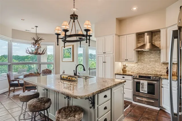a kitchen with a sink stainless steel appliances and cabinets
