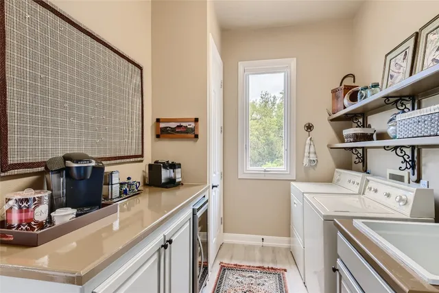 a view of a kitchen with a sink washer and dryer