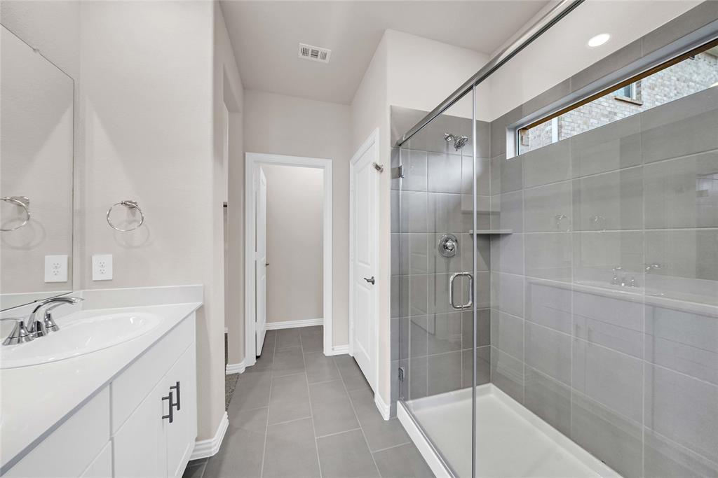 417 Martell Road Lowry Crossing, TX 75069 - Photo 17 of 29 a bathroom with a double vanity sink and mirror