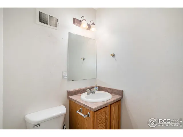 a bathroom with a sink toilet and a mirror