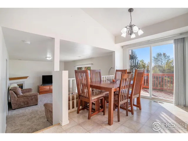 a view of a dining room with furniture wooden floor and chandelier