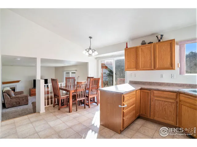a living room with stainless steel appliances kitchen island granite countertop furniture and a view of kitchen