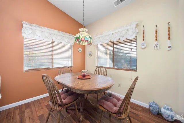 a view of a dining room with furniture and window