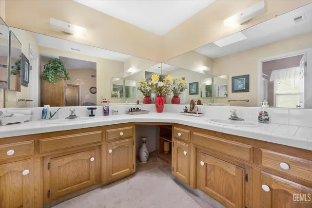 a spacious bathroom with a double vanity sink and a mirror