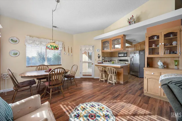 a dining room with furniture a chandelier and wooden floor