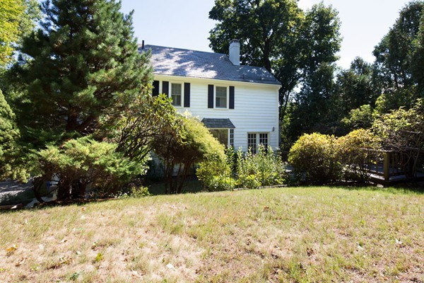 a view of a house with a yard covered with snow in front of house