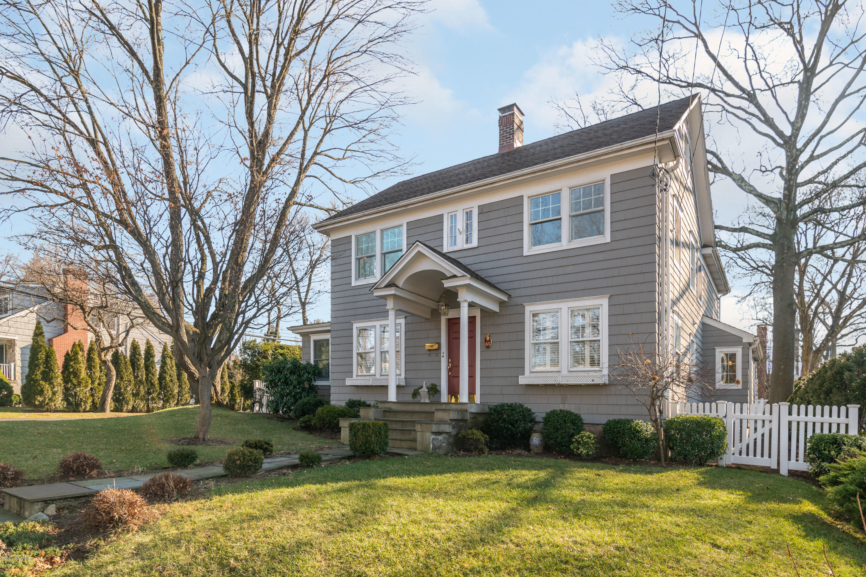 a front view of a house with a yard table and chairs
