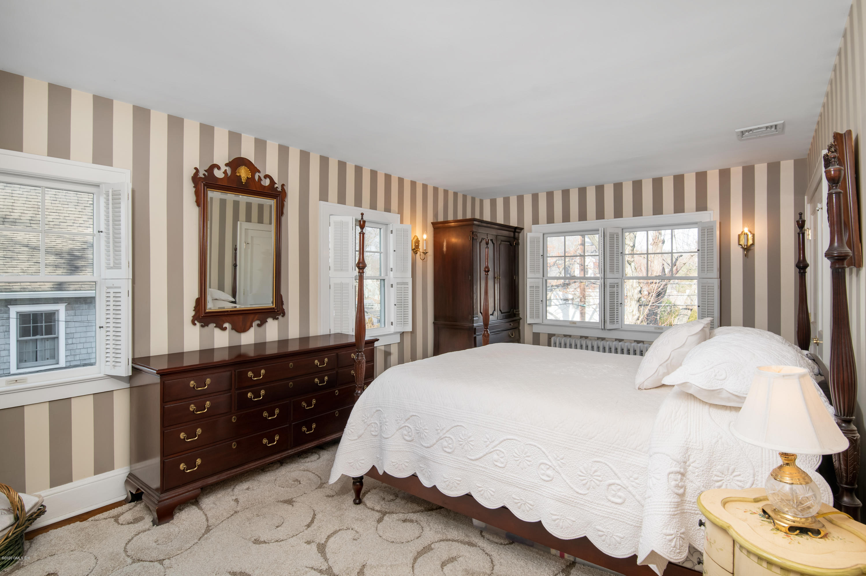 18 Stuart Drive Old Greenwich, CT 06870 - Photo 11 of 25 a bedroom with a bed dresser and a window