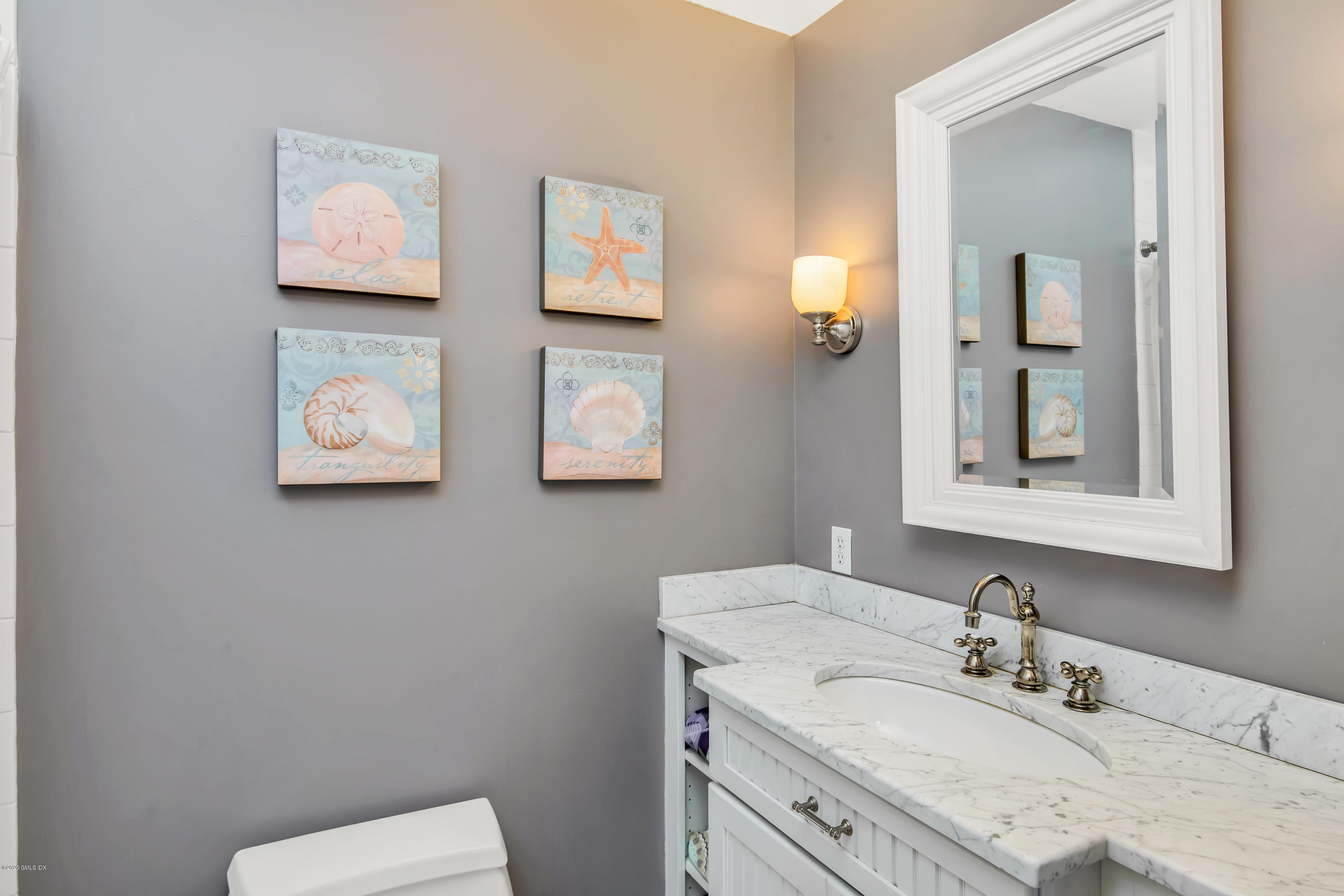 18 Stuart Drive Old Greenwich, CT 06870 - Photo 14 of 25 a bathroom with a granite countertop sink mirror and toilet
