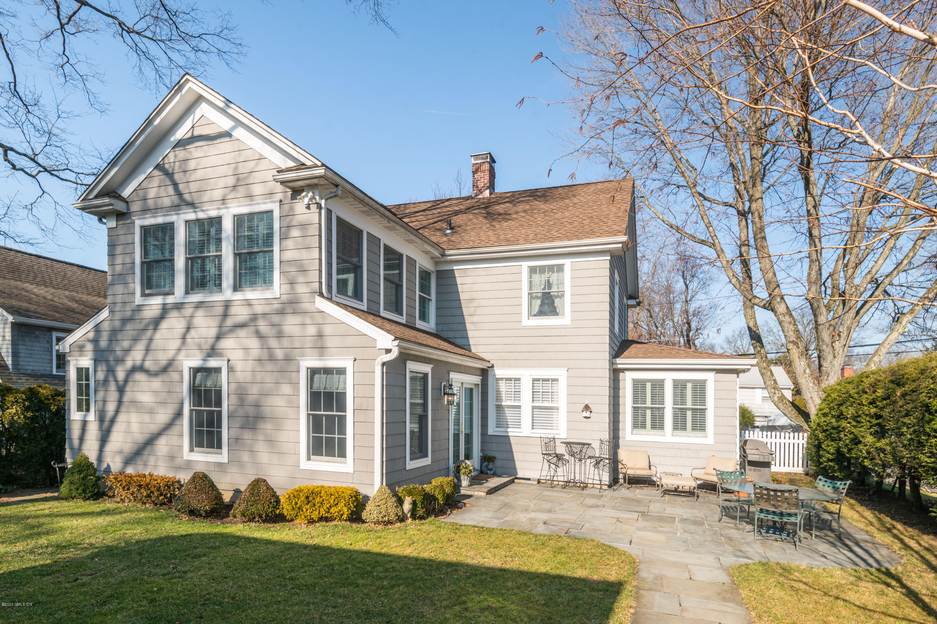 18 Stuart Drive Old Greenwich, CT 06870 - Photo 18 of 25 a front view of a house with a yard
