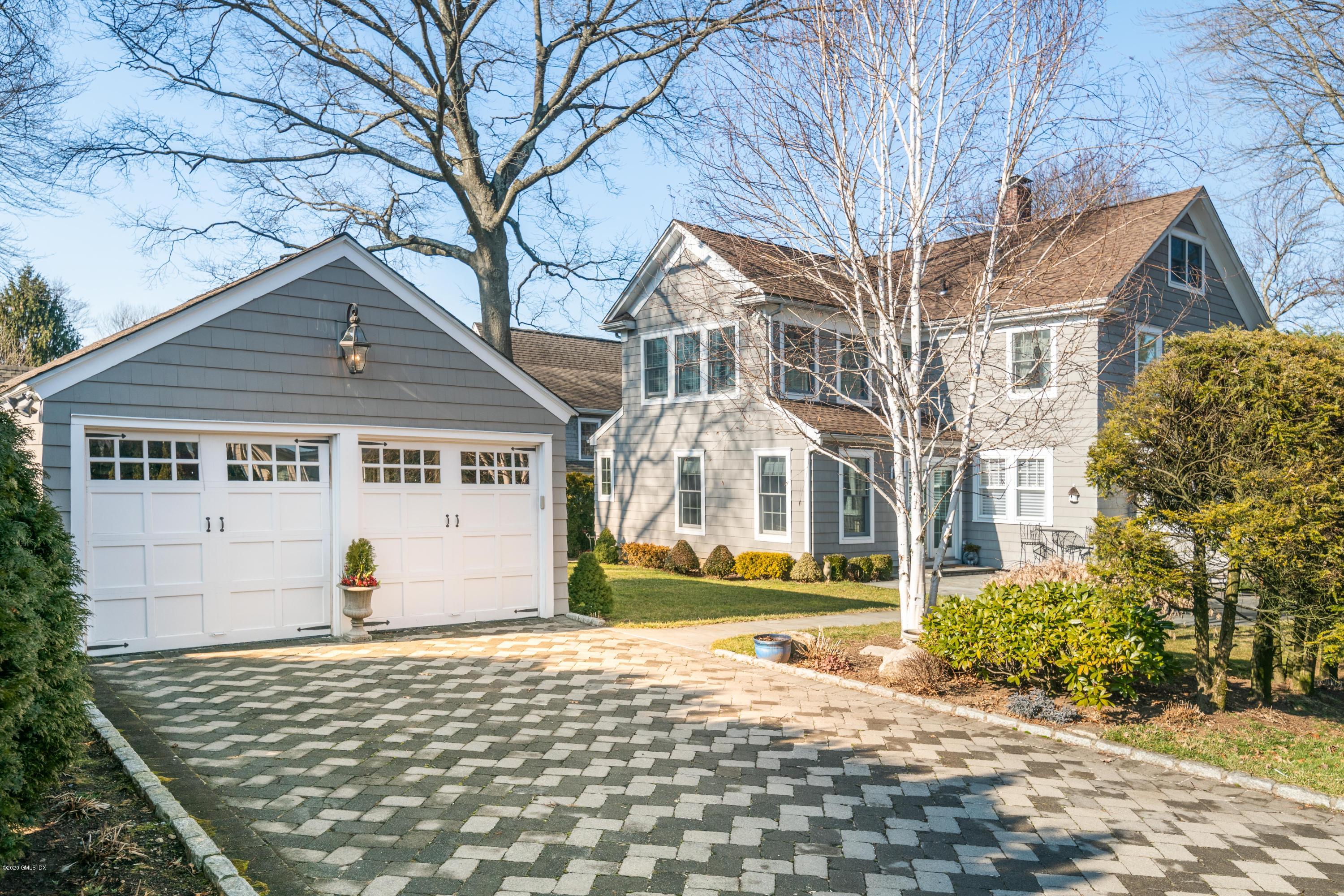 18 Stuart Drive Old Greenwich, CT 06870 - Photo 20 of 25 a view of a white house with a large tree