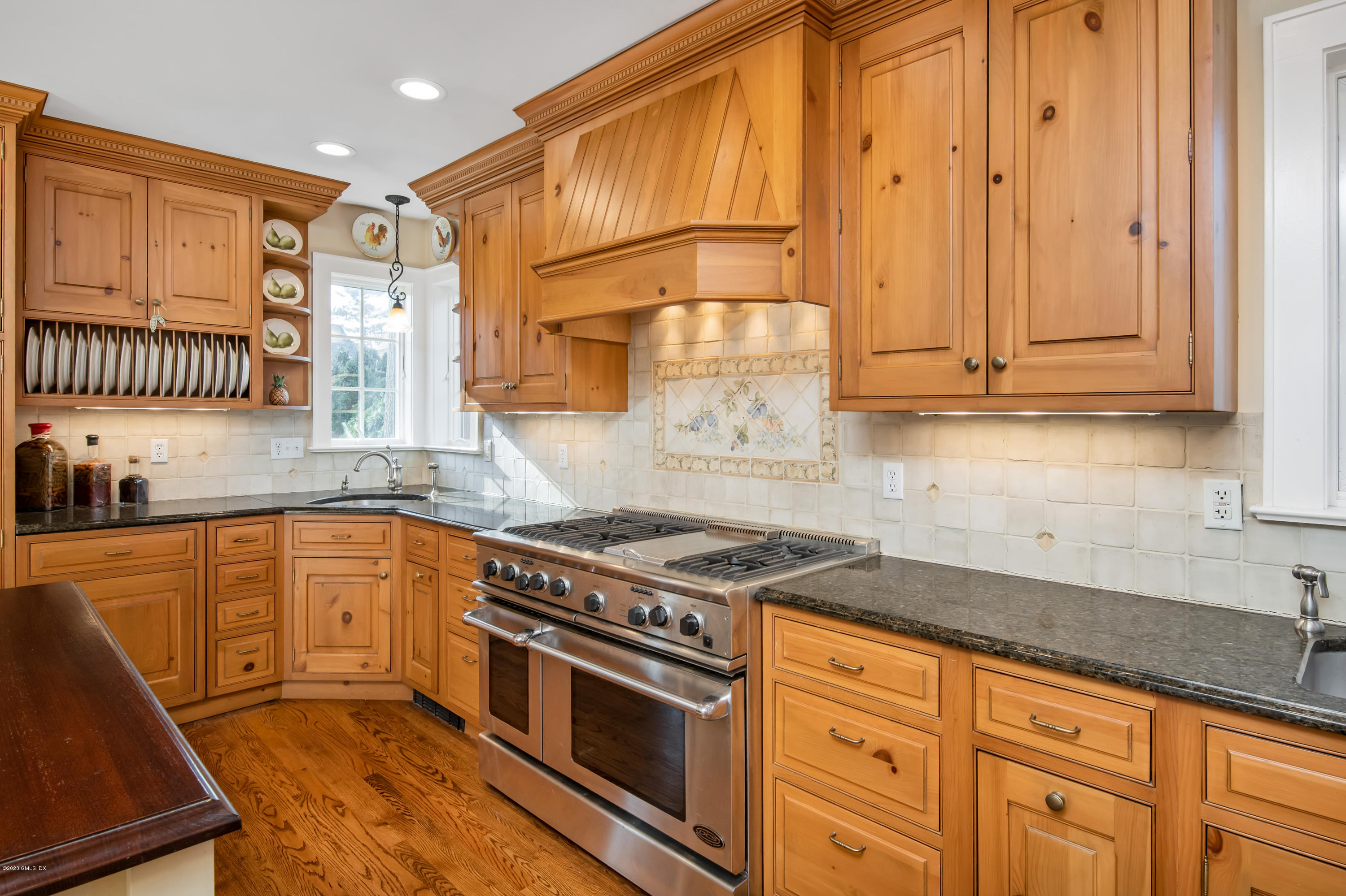 18 Stuart Drive Old Greenwich, CT 06870 - Photo 6 of 25 a kitchen with granite countertop a sink a stove and cabinets