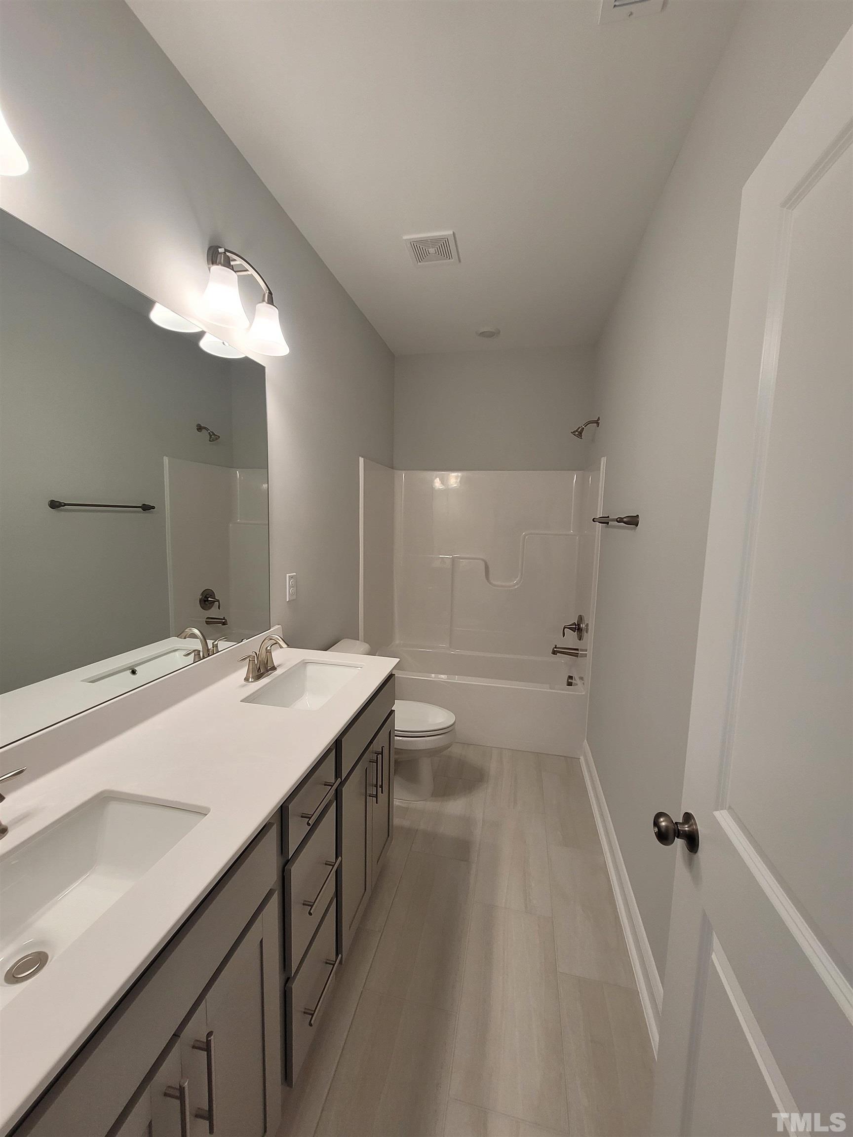 124 Trailing Bluff Way Garner, NC 27529 - Photo 14 of 21 a bathroom with a sink a toilet and shower