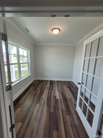 a view of a room with wooden floor and staircase