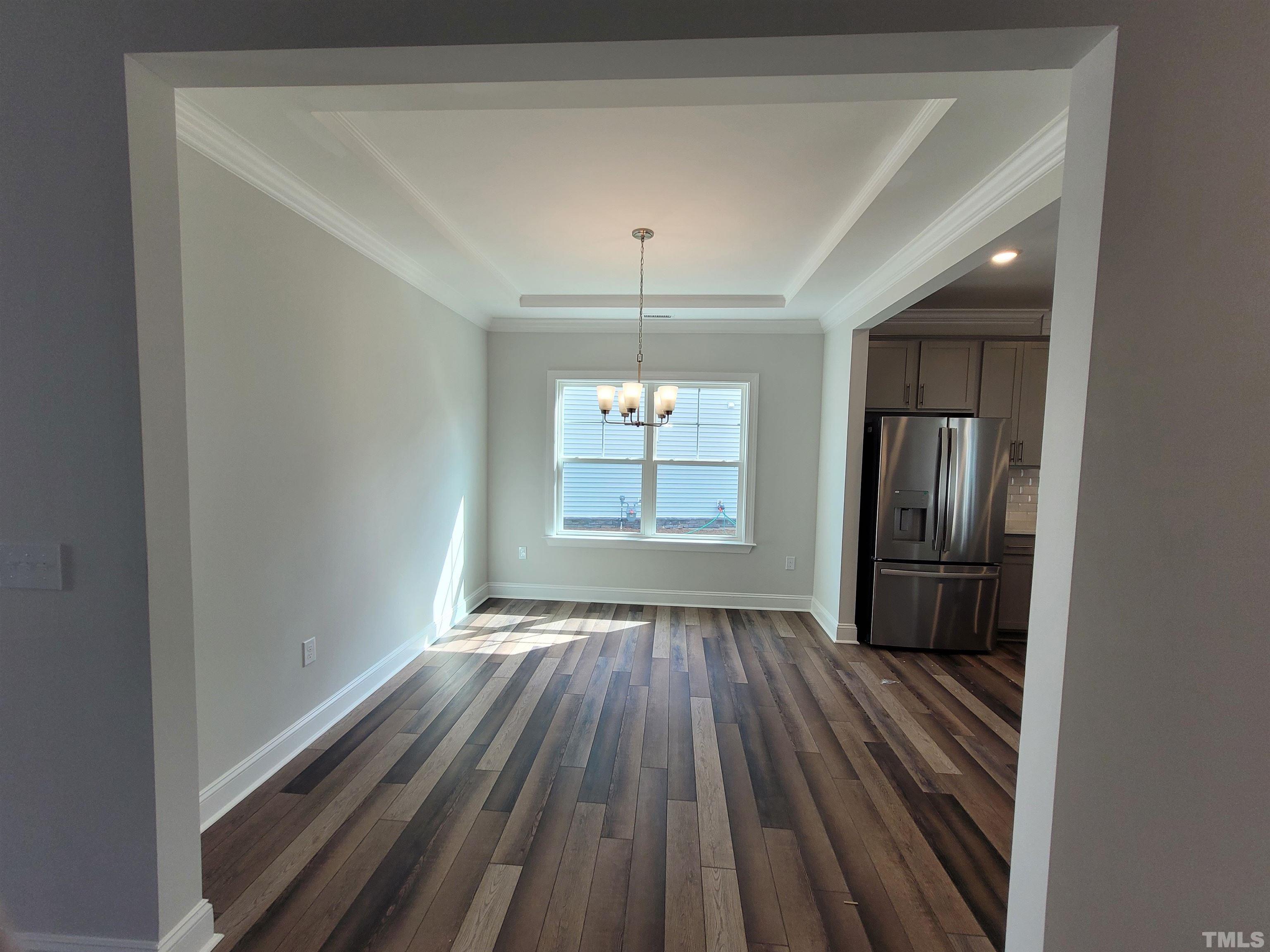 124 Trailing Bluff Way Garner, NC 27529 - Photo 7 of 21 a view of empty room with wooden floor and fan