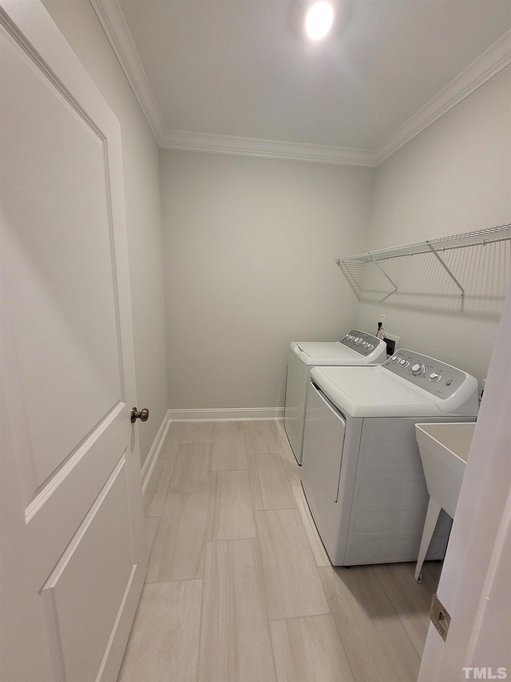 124 Trailing Bluff Way Garner, NC 27529 - Photo 9 of 21 a utility room with a sink dryer and washer