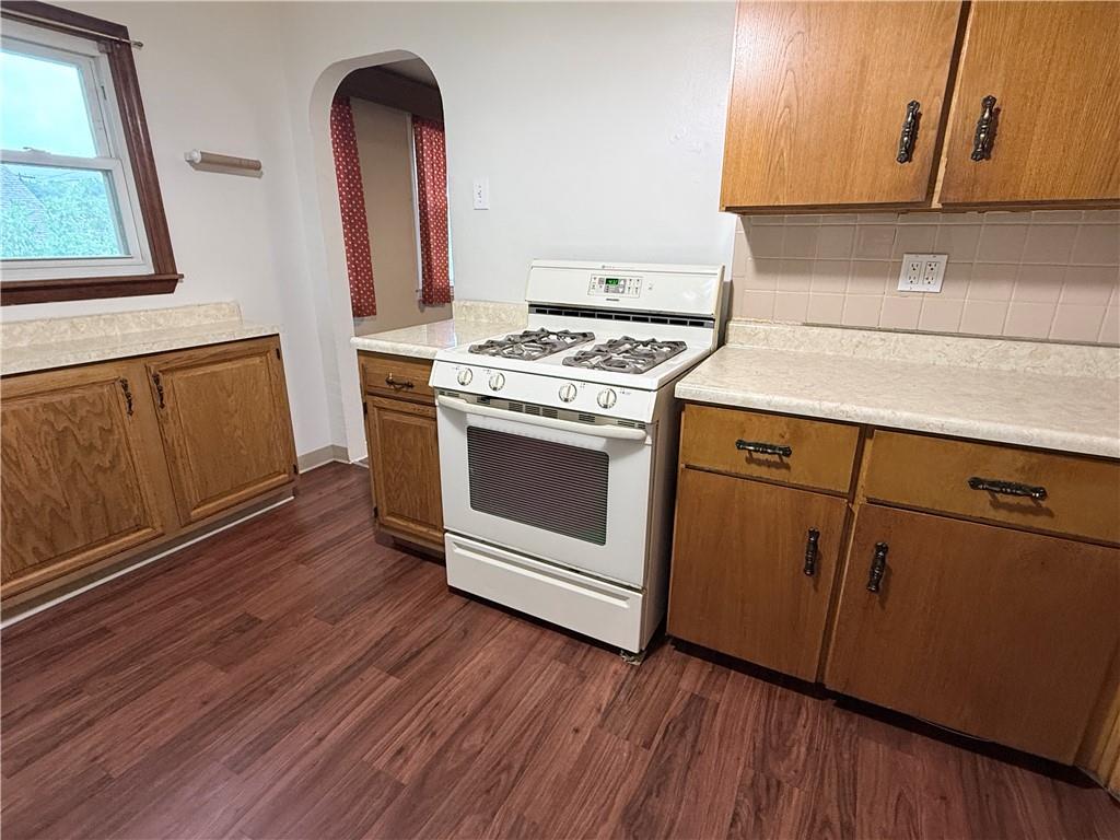112 Greydon Avenue McKees Rocks, PA 15136 - Photo 10 of 14 a kitchen with granite countertop wooden floors and white stainless steel appliances