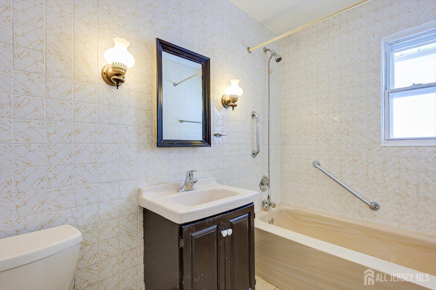 27 Stiles Road Edison, NJ 08817 - Photo 13 of 20 a bathroom with a sink a toilet and shower