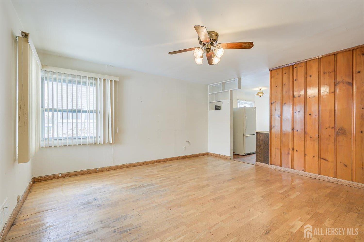27 Stiles Road Edison, NJ 08817 - Photo 4 of 20 wooden floor in an empty room with a window