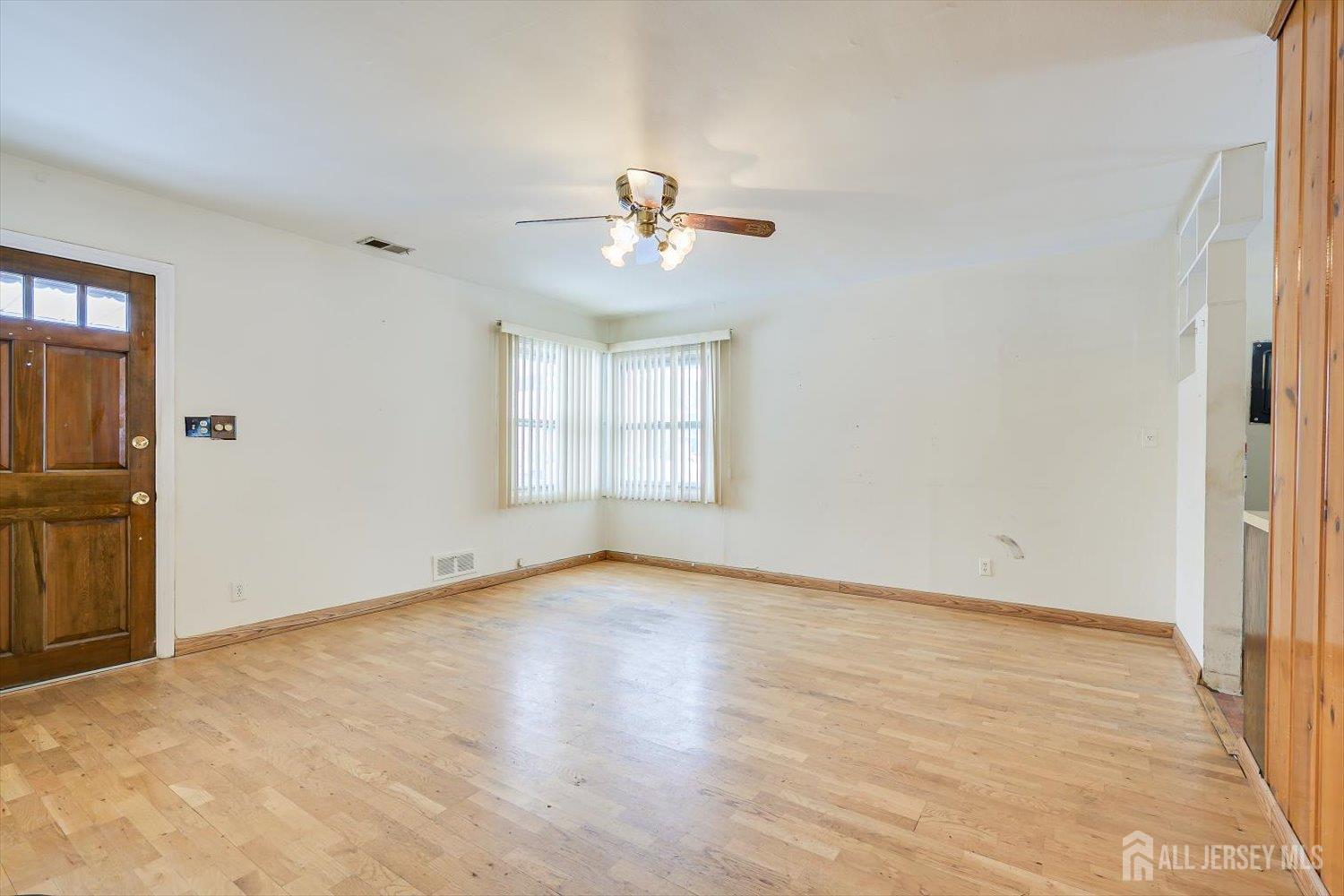 27 Stiles Road Edison, NJ 08817 - Photo 5 of 20 wooden floor in an empty room with a window