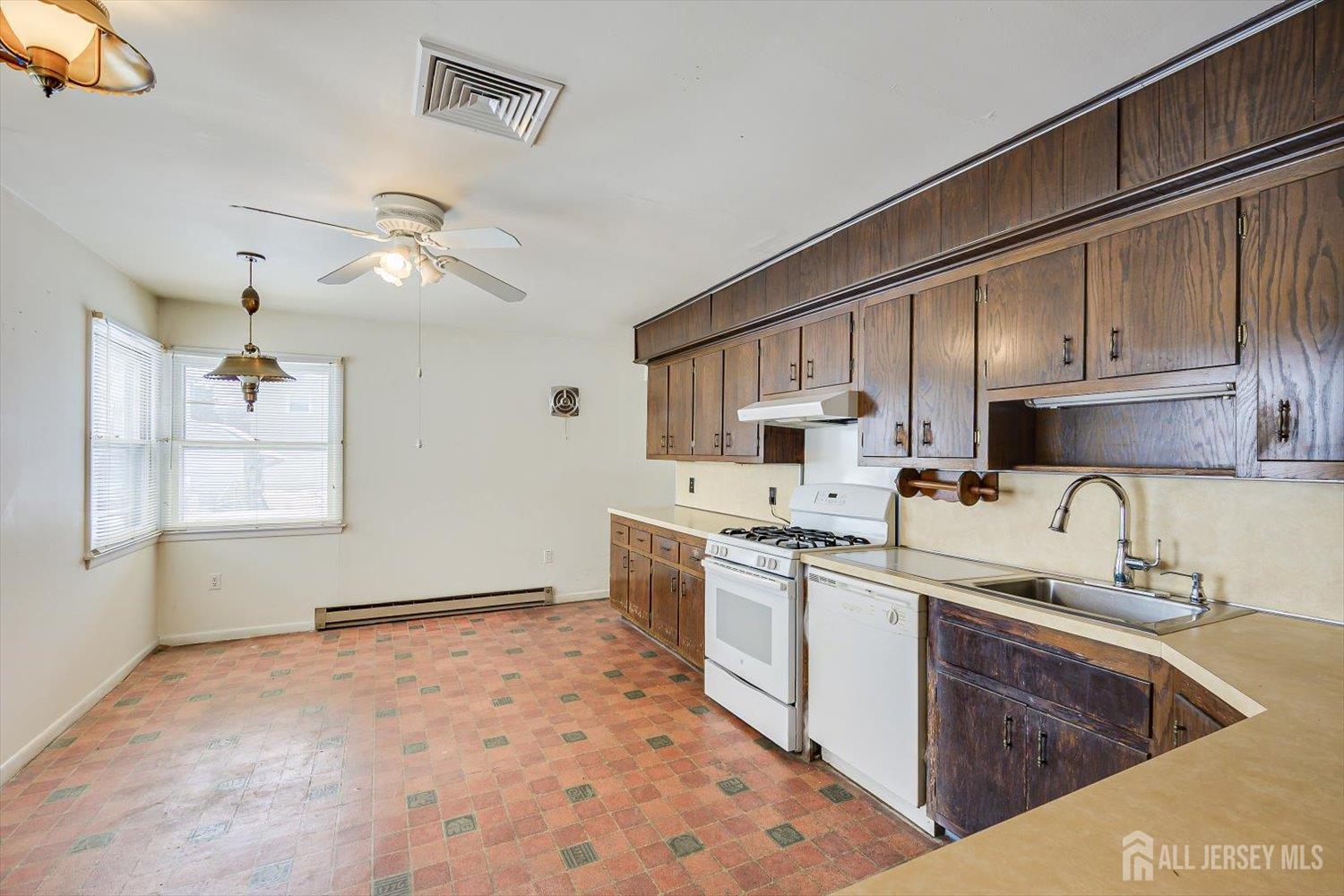 27 Stiles Road Edison, NJ 08817 - Photo 8 of 20 a kitchen with stainless steel appliances granite countertop a sink a stove and cabinets