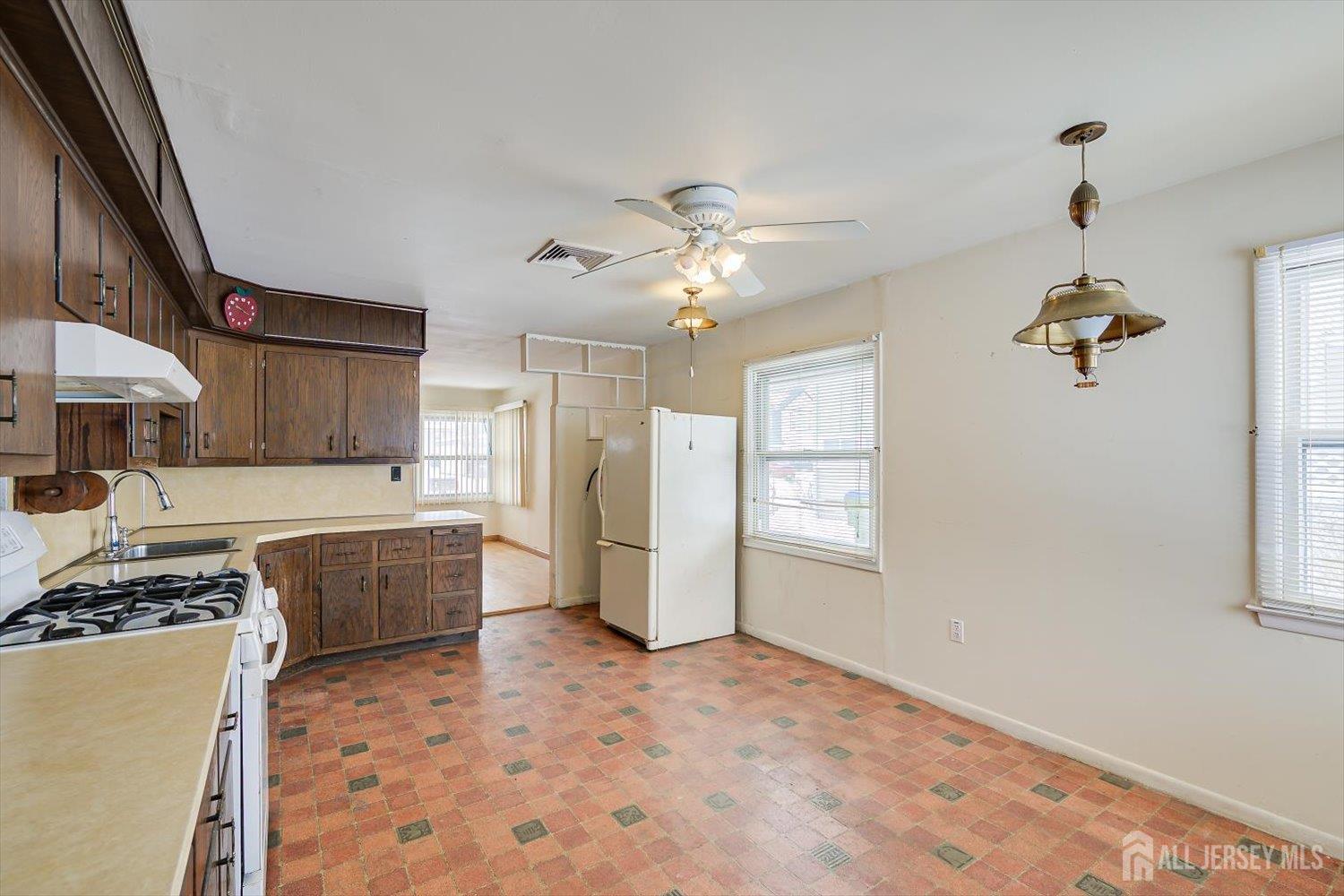 27 Stiles Road Edison, NJ 08817 - Photo 10 of 20 a kitchen that has a lot of cabinets stainless steel appliances and a chandelier