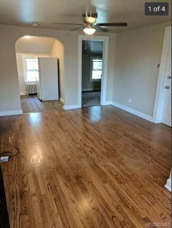 wooden floor in an empty room with a mirror