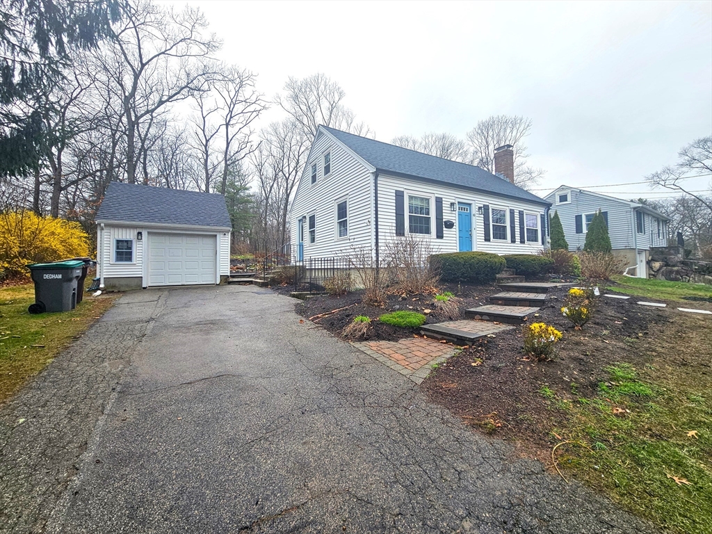61 Ledgewood Road Dedham, MA 02026 - Photo 1 of 23 a front view of a house with a yard and a garage