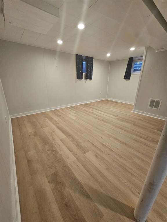 61 Ledgewood Road Dedham, MA 02026 - Photo 17 of 23 an empty room with a wooden floor and windows