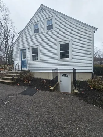 a front view of house with yard and trees