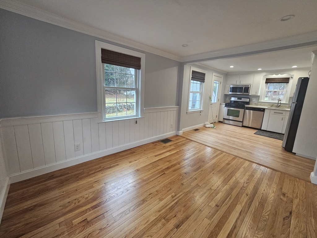 61 Ledgewood Road Dedham, MA 02026 - Photo 2 of 23 a view of a kitchen with wooden floor and a window