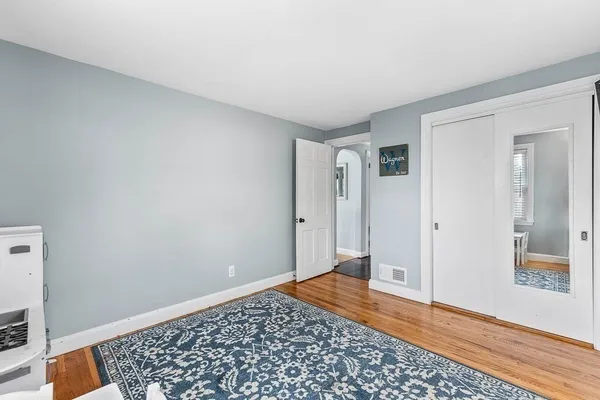 a bedroom with a bed and a dresser