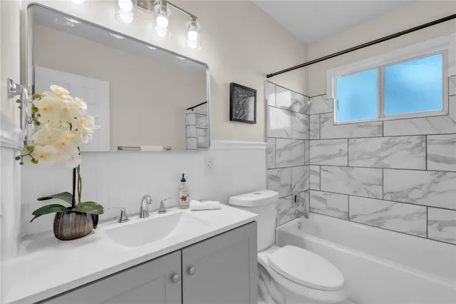 a bathroom with a sink a toilet and bathtub