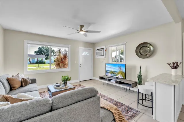 a living room with furniture a clock and a window