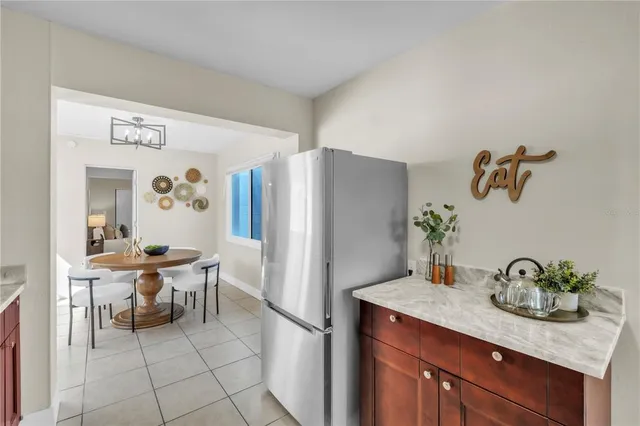 a kitchen with stainless steel appliances granite countertop a sink and a refrigerator