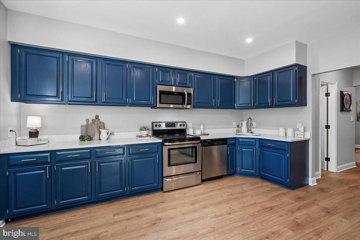 817 4th Street Northeast Washington, DC 20002 - Photo 11 of 40 a kitchen with stainless steel appliances granite countertop wooden cabinets a stove a sink and a granite counter top